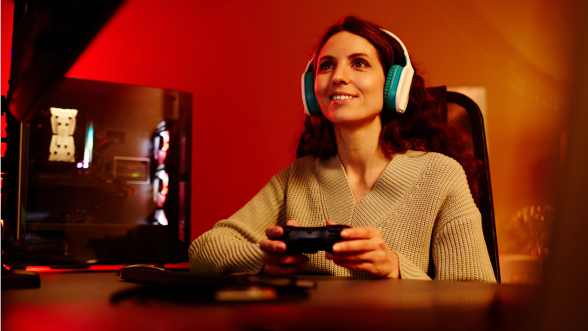 picture of a woman wearing headphones and playing games with her controller