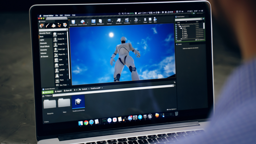 game developer creating on main screen of unreal engine software on an apple macbook